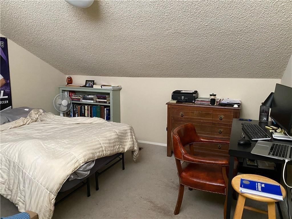 2815 Rio Grande Street, Unit 206 Austin, TX 78705 - Photo 2 of 6 a bedroom with a bed and furniture