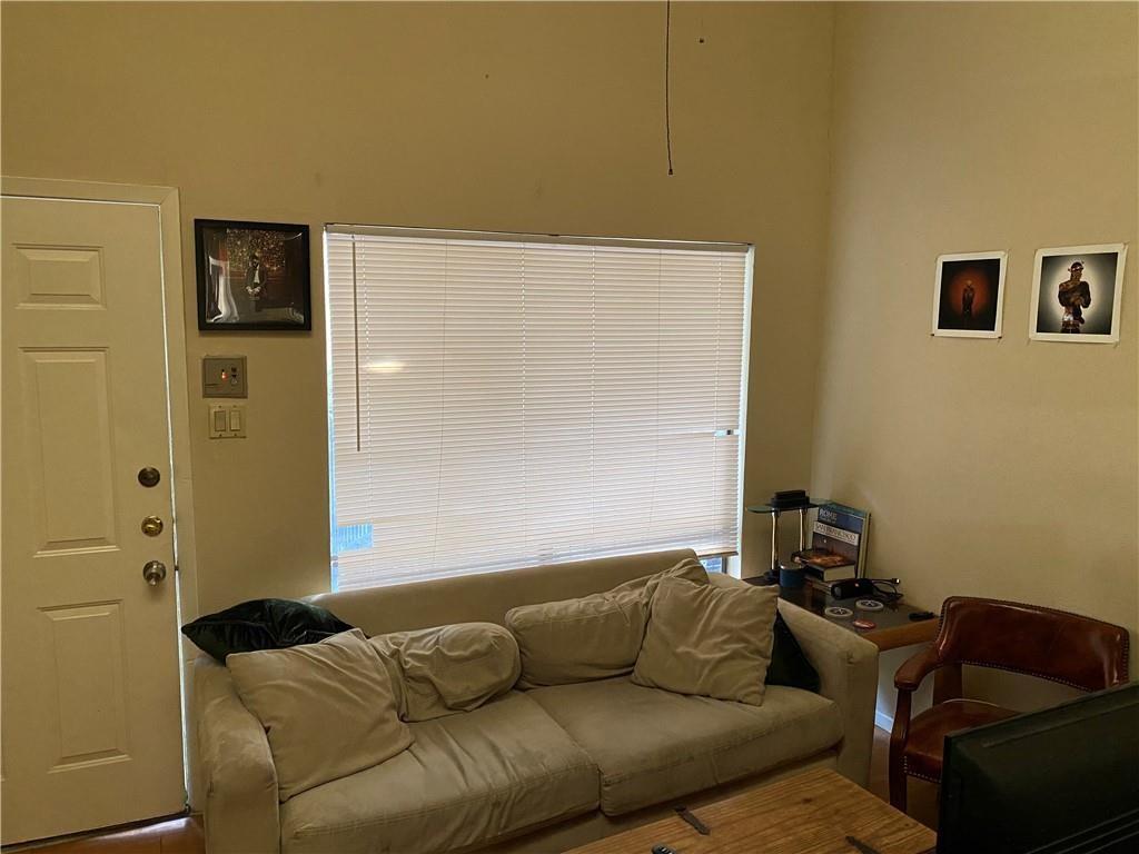 2815 Rio Grande Street, Unit 206 Austin, TX 78705 - Photo 6 of 6 a living room with furniture and a couch