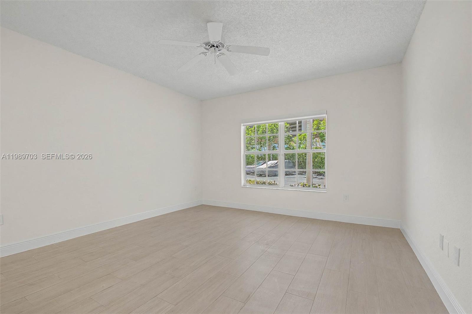 7000 Southwest 80th Street, Unit 103 Miami, FL 33143 - Photo 11 of 16 an empty room with a window