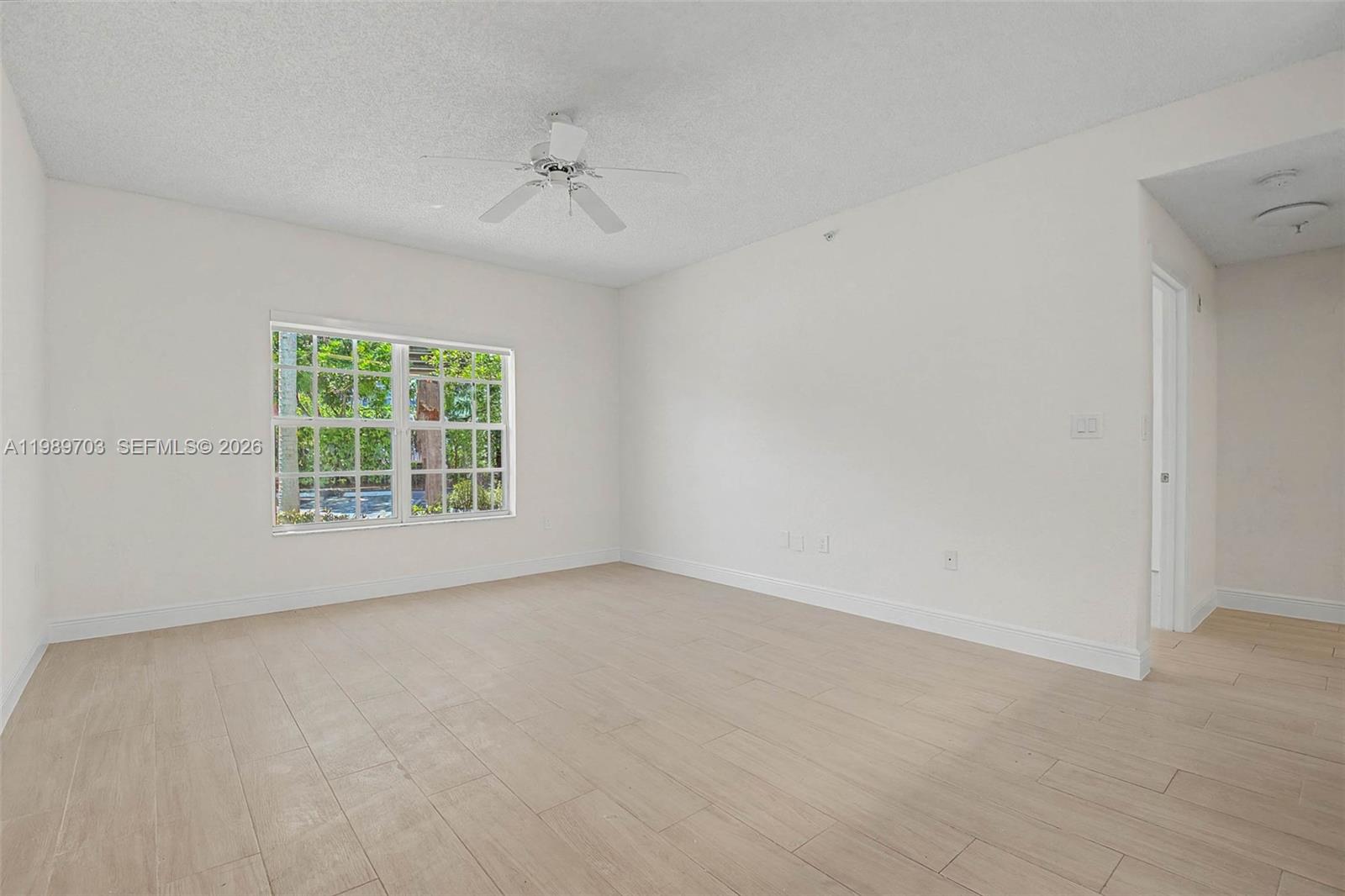 7000 Southwest 80th Street, Unit 103 Miami, FL 33143 - Photo 5 of 16 an empty room with a window