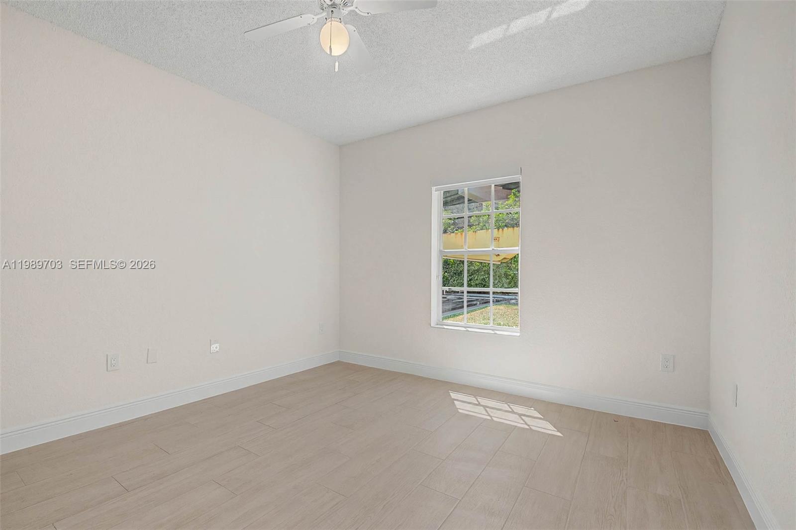 7000 Southwest 80th Street, Unit 103 Miami, FL 33143 - Photo 7 of 16 an empty room with a window