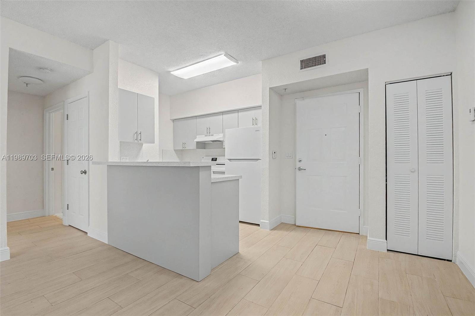 7000 Southwest 80th Street, Unit 103 Miami, FL 33143 - Photo 10 of 16 a view of a kitchen with white cabinets