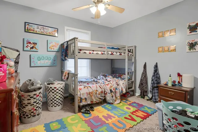 a bedroom with baby toys and dresser