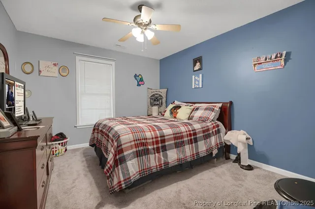 a bedroom with a bed and a dresser in it