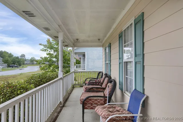 a balcony with chairs and a couple of chairs