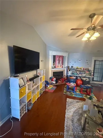 a view of a livingroom with furniture and a flat screen tv