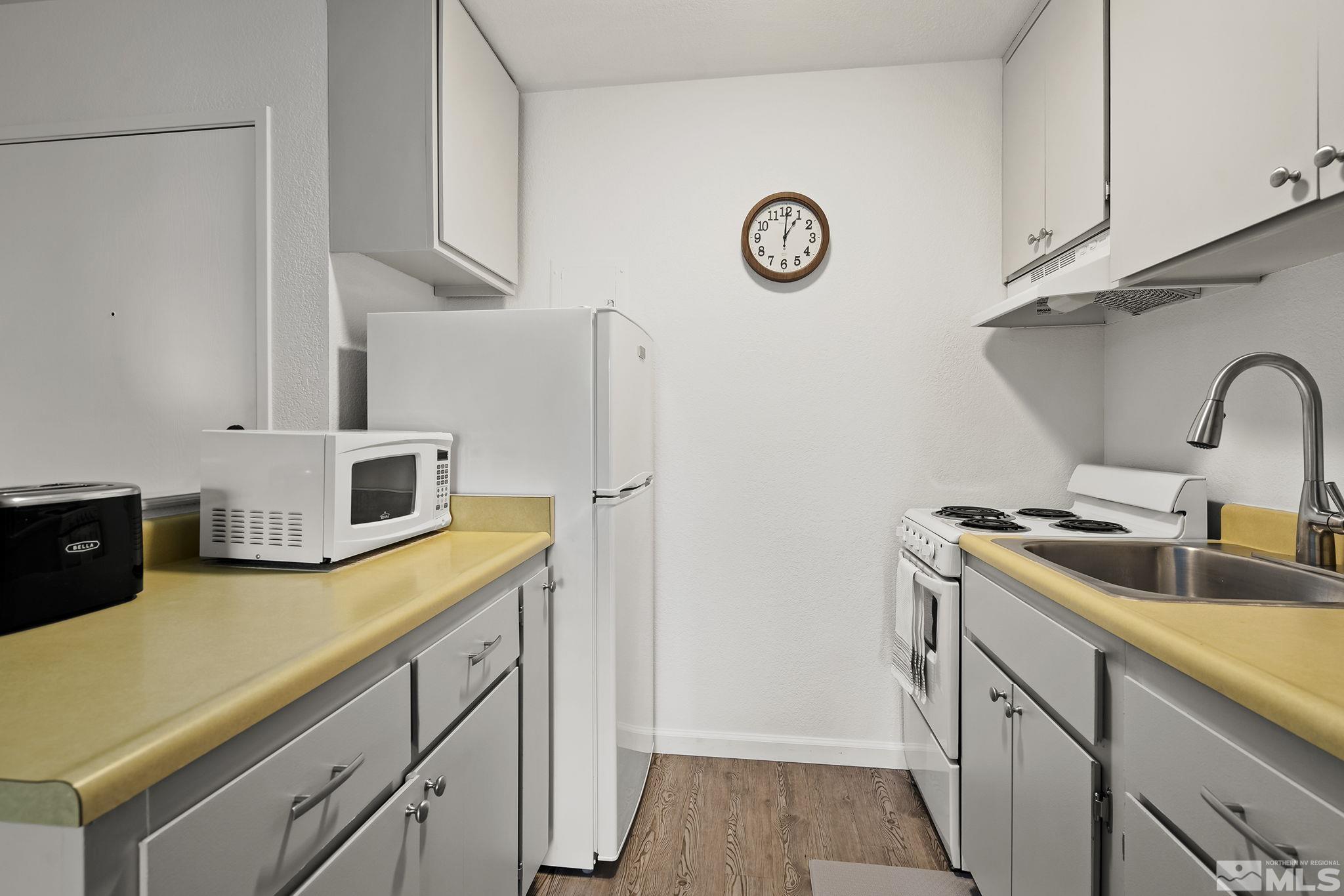2450 Lymbery Street, Unit 214 Reno, NV 89509 - Photo 5 of 13 a kitchen with stainless steel appliances granite countertop a sink a stove and a refrigerator