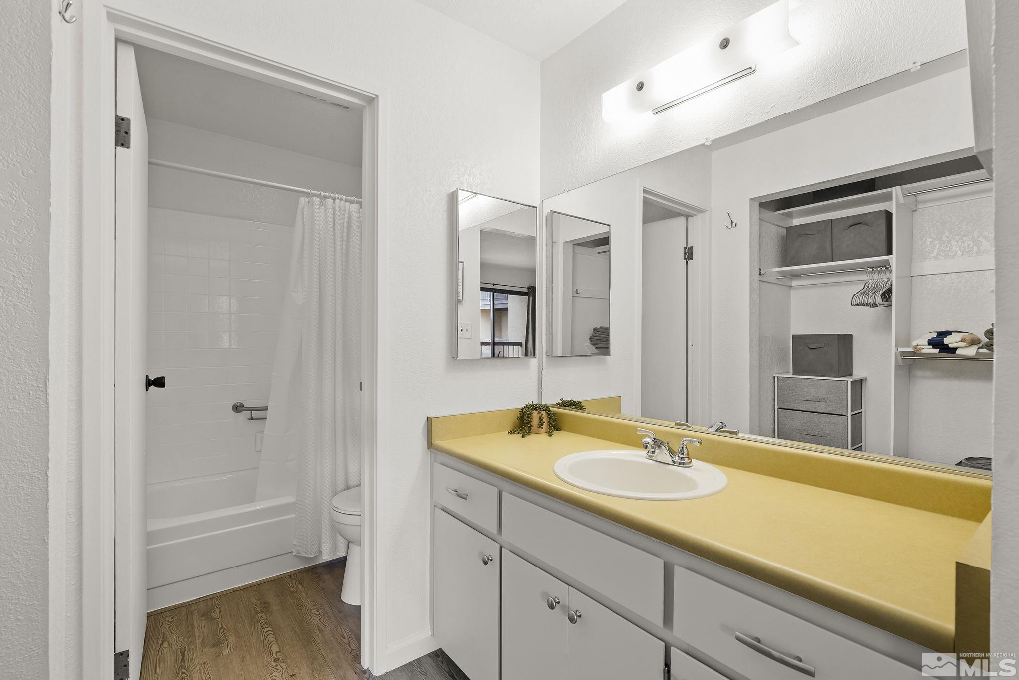 2450 Lymbery Street, Unit 214 Reno, NV 89509 - Photo 8 of 13 a spacious bathroom with a granite countertop tub sink and mirror