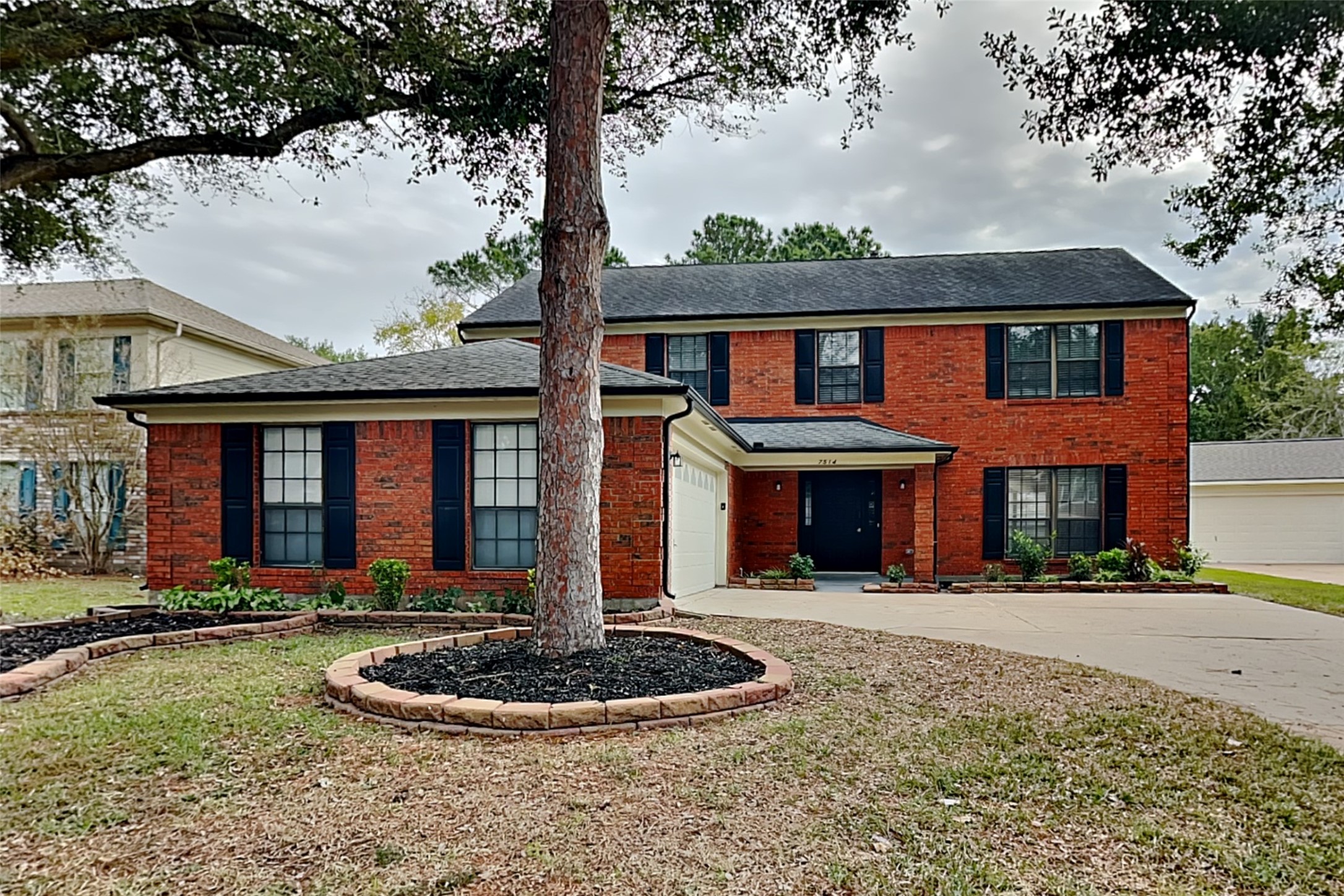a front view of a house with yard and porch