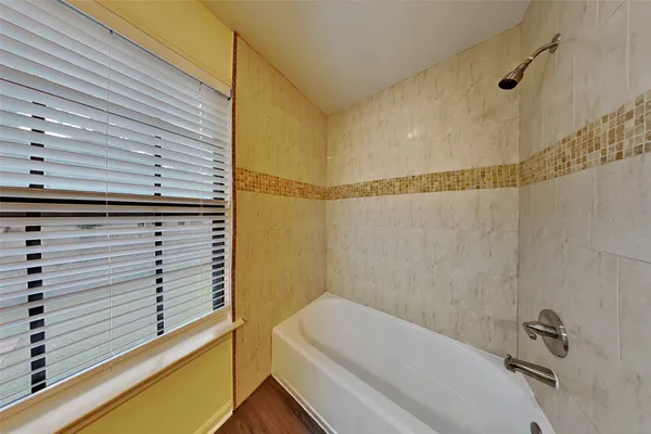 a bathroom with a bathtub and shower