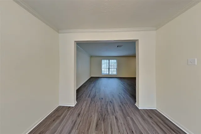 a view of a room with wooden floor and window