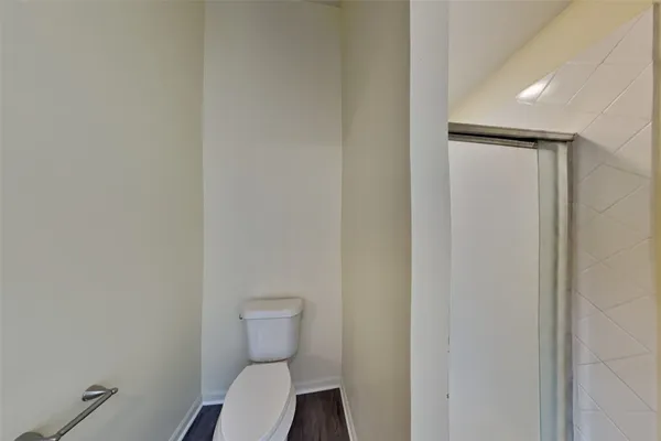 a bathroom with a toilet and a shower
