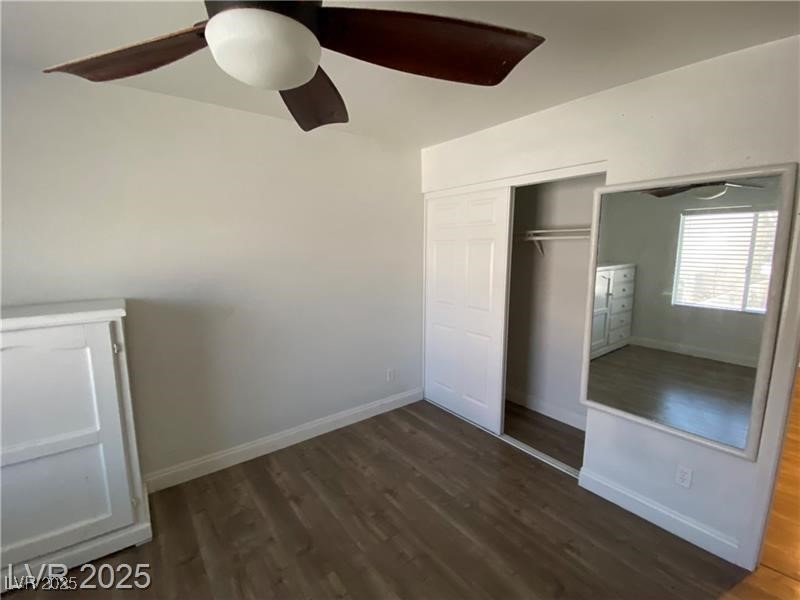 1154 Warm Sun Court Las Vegas, NV 89110 - Photo 12 of 19 Unfurnished bedroom featuring dark wood-style floors, ceiling fan, and a closet
