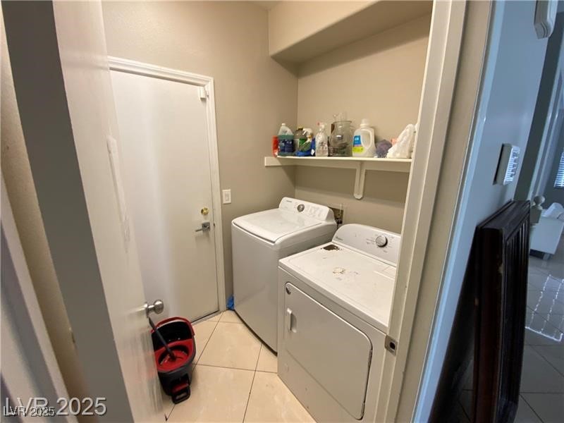 1154 Warm Sun Court Las Vegas, NV 89110 - Photo 14 of 19 Laundry area with light tile patterned floors and independent washer and dryer