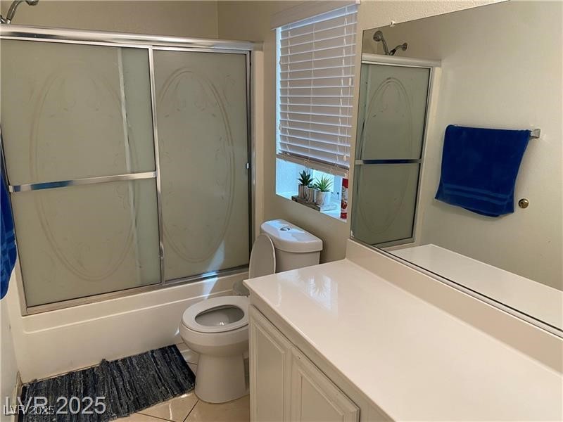 1154 Warm Sun Court Las Vegas, NV 89110 - Photo 3 of 19 Bathroom with bath / shower combo with glass door, vanity, and light tile patterned floors
