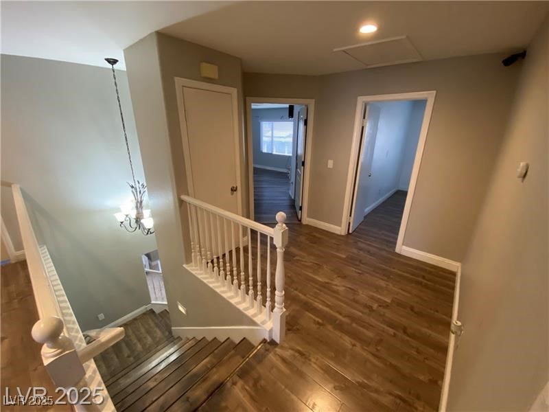 1154 Warm Sun Court Las Vegas, NV 89110 - Photo 6 of 19 Stairway featuring wood finished floors and a chandelier