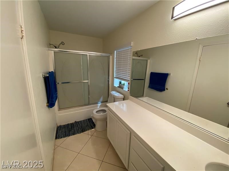 1154 Warm Sun Court Las Vegas, NV 89110 - Photo 7 of 19 Bathroom featuring combined bath / shower with glass door, vanity, and light tile patterned floors