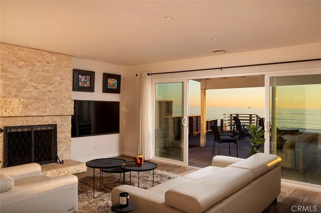 a living room with furniture a large window and a fireplace
