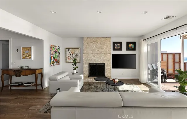 a living room with furniture a rug and a large window