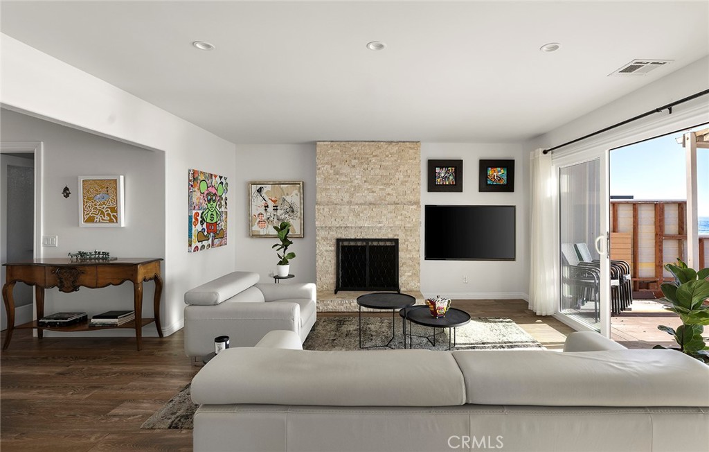 35661 Beach Road Dana Point, CA 92624 - Photo 13 of 52 a living room with furniture a large window and a fireplace