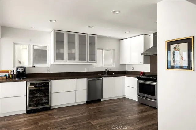 a kitchen with a sink stove and refrigerator