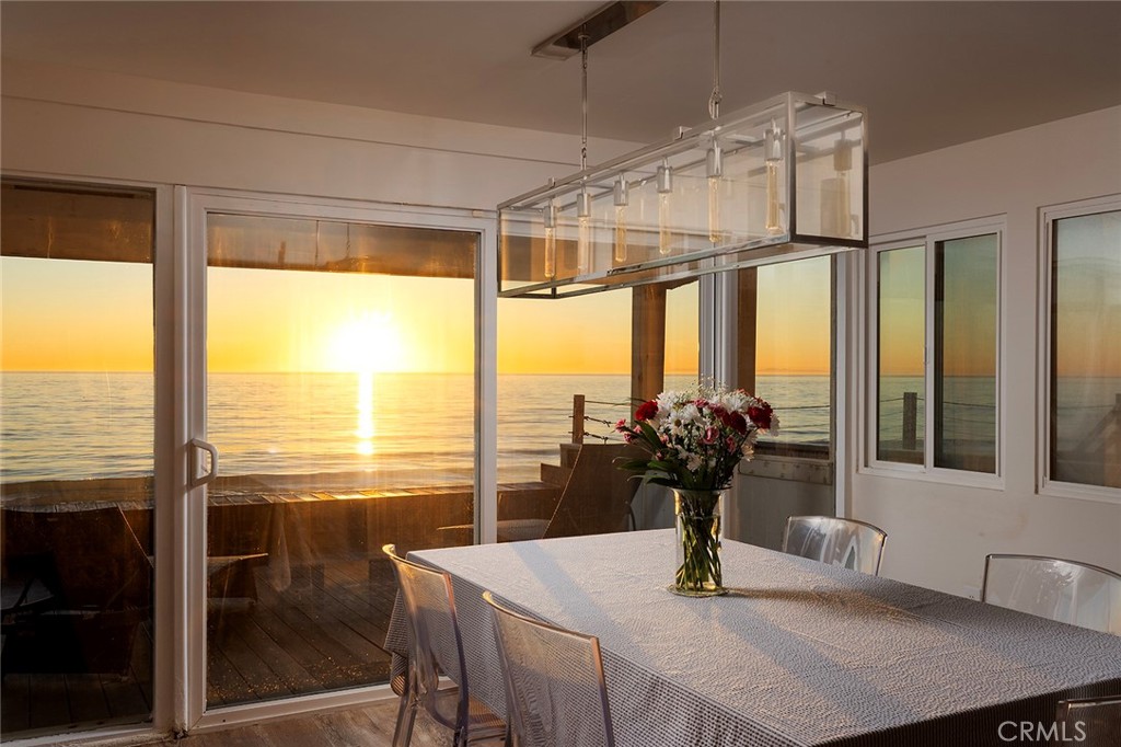 35661 Beach Road Dana Point, CA 92624 - Photo 21 of 52 a dining room with furniture and large windows