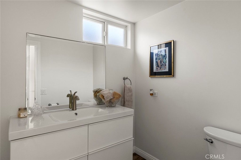 35661 Beach Road Dana Point, CA 92624 - Photo 25 of 52 a bathroom with a sink and mirror with toilet