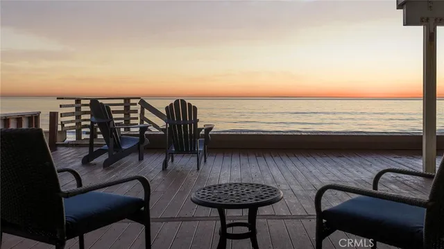 a view of roof deck with two chairs and wooden floor