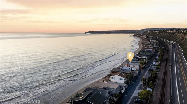 a bedroom with a large bed and a flat tv screen on dresser