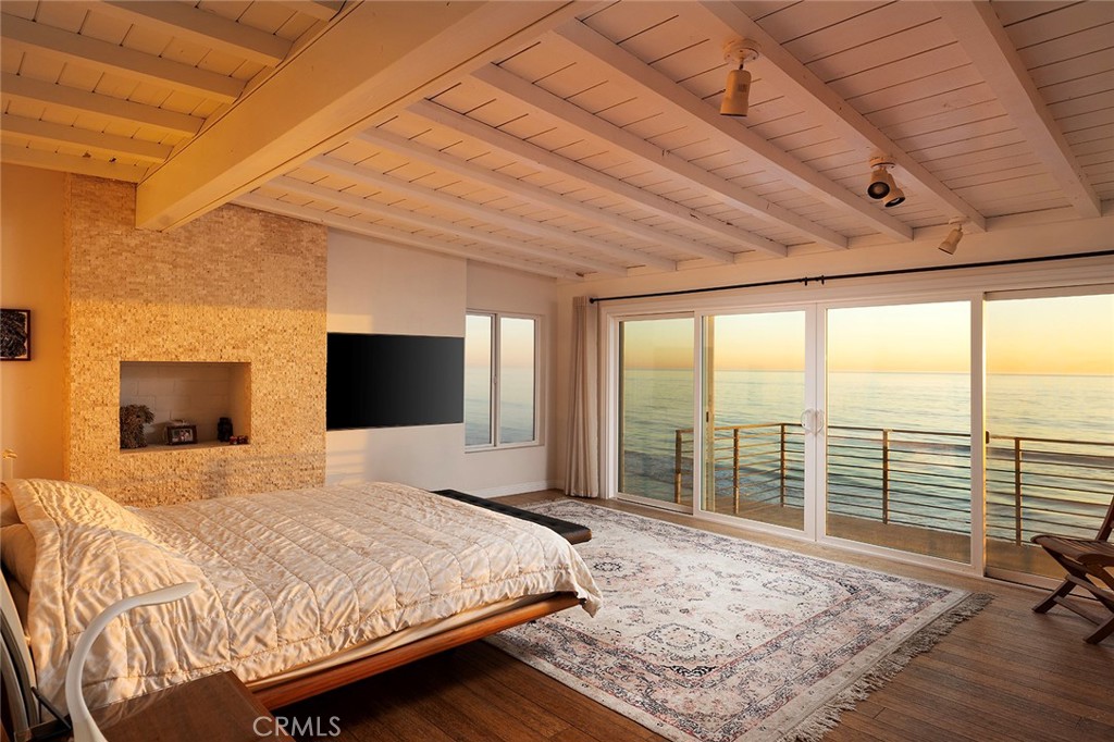 35661 Beach Road Dana Point, CA 92624 - Photo 38 of 52 a bedroom with a large bed and a flat tv screen on dresser