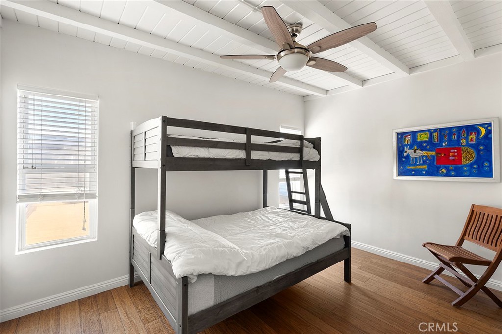 35661 Beach Road Dana Point, CA 92624 - Photo 48 of 52 a bedroom with a bed and wooden floor