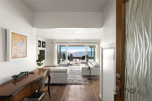 a living room with furniture fireplace and a large window