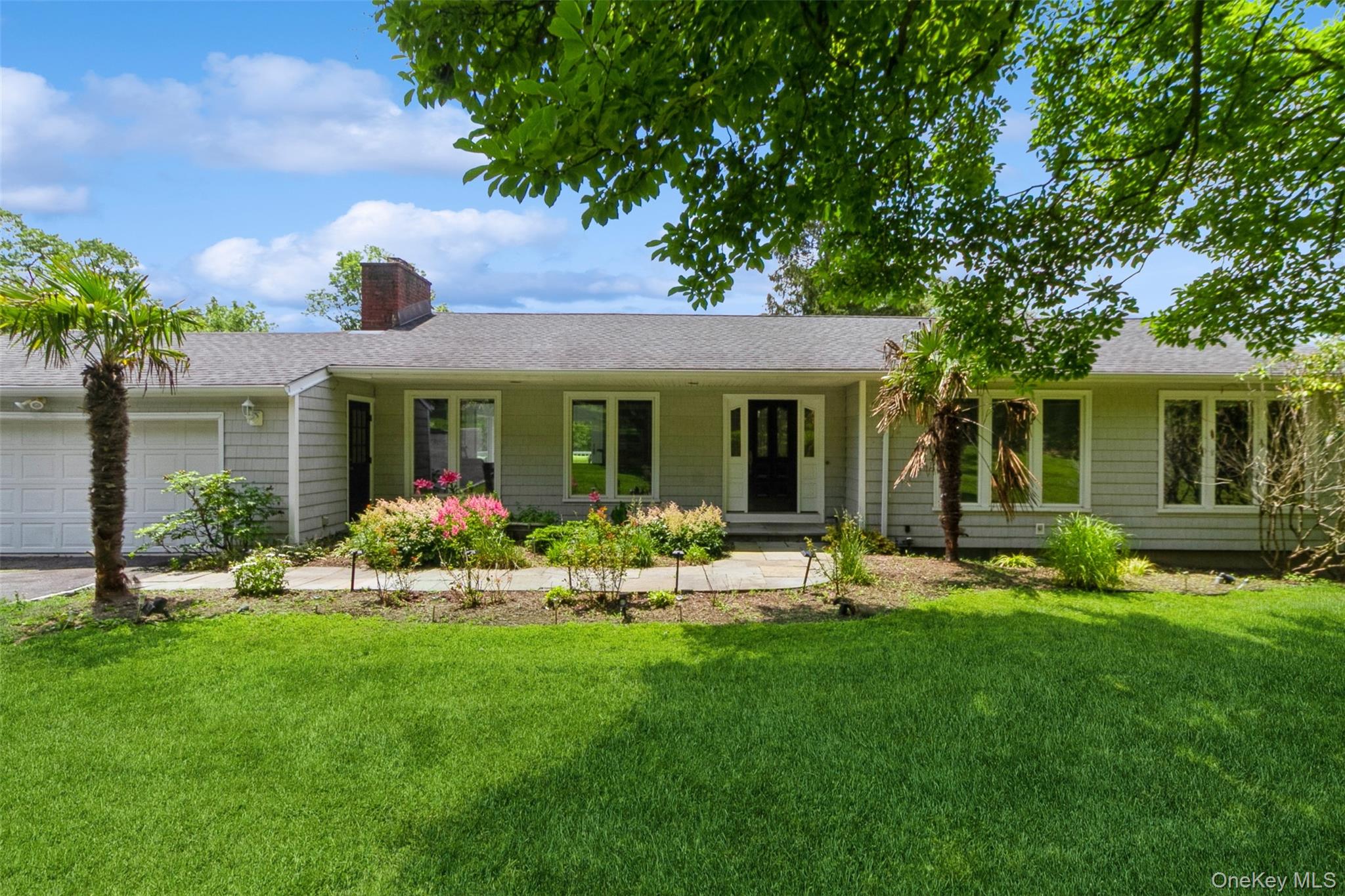 a front view of a house with a garden and porch
