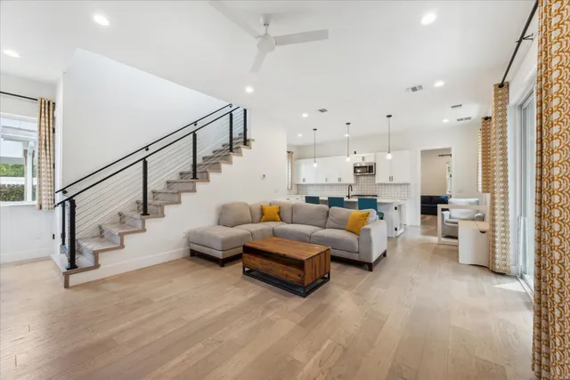 a living room with furniture and a chandelier