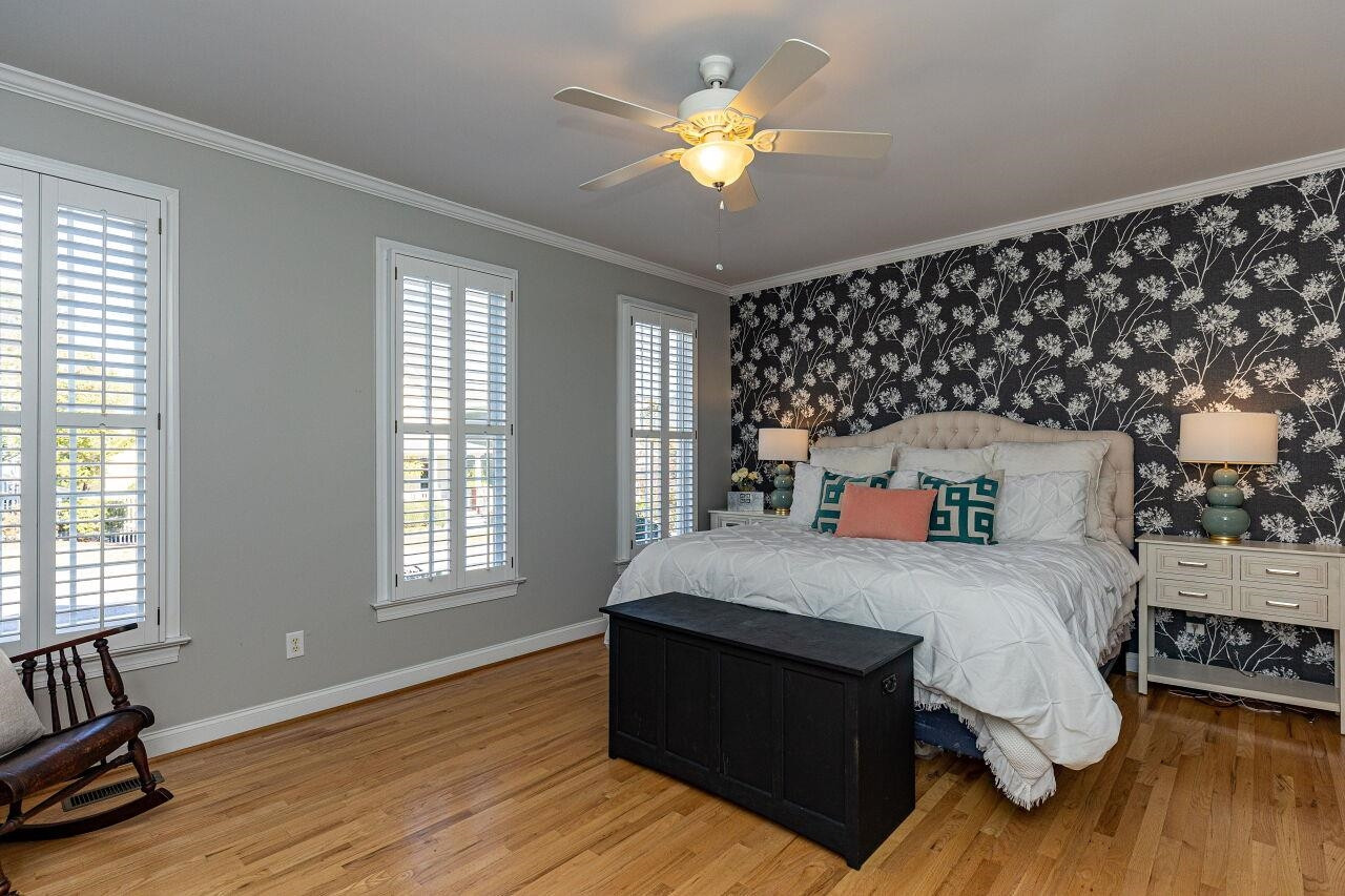 Spacious first floor primary. Gleaming hardwoods, large closet, fan and plantation shutters. Designer wallpaper is peel and stick for easy removal if you choose. Master Bedroom