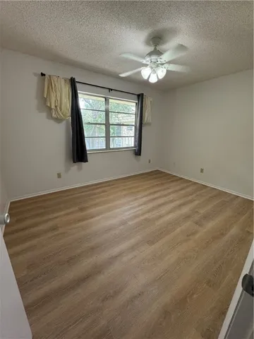 wooden floor in an empty room with a mirror