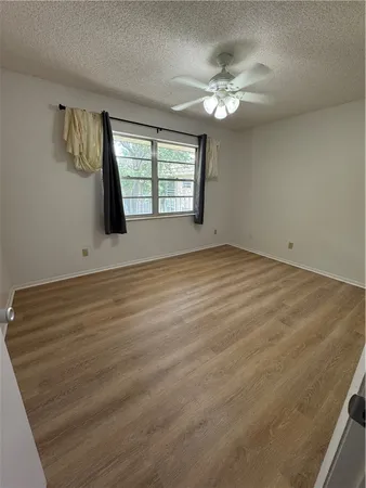 wooden floor in an empty room with a mirror
