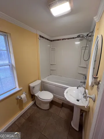 a view of a hallway with wooden floor and stairs