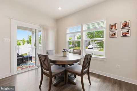 a dining room with furniture and wooden floor