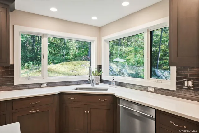 a kitchen with a large window sink and cabinets