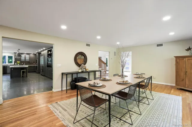 a dining room with wooden floor and a table