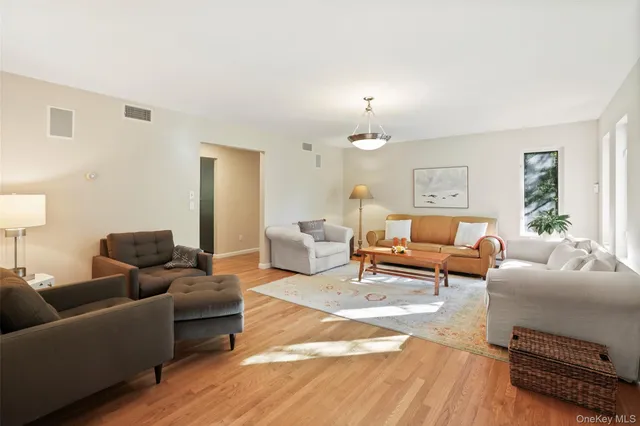 a living room with furniture and a lamp