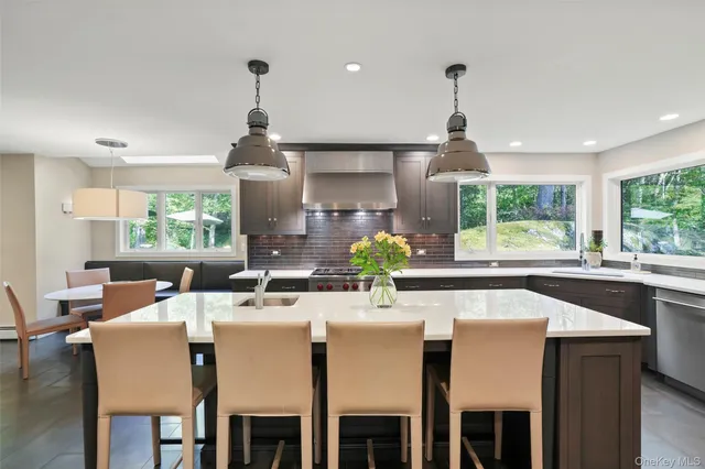 a kitchen with a table chairs stove and cabinets
