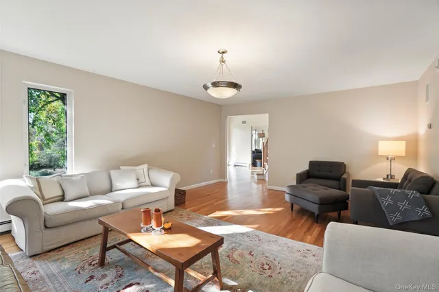 a living room with furniture a rug and a chandelier