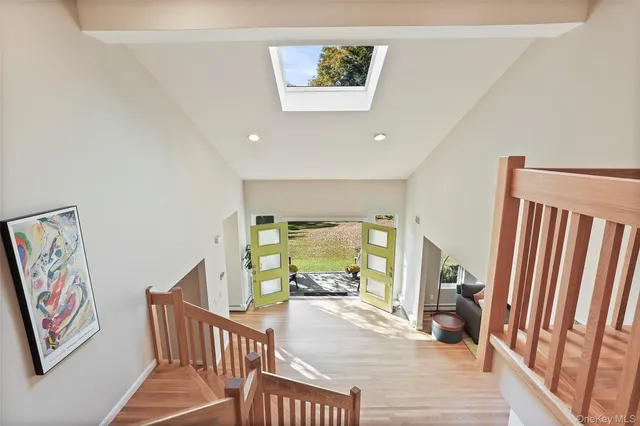 a view of a hallway with wooden floor and windows