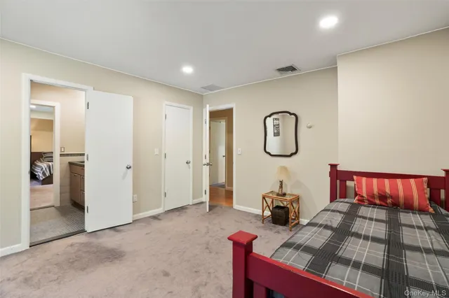 a bedroom with bed and a chandelier