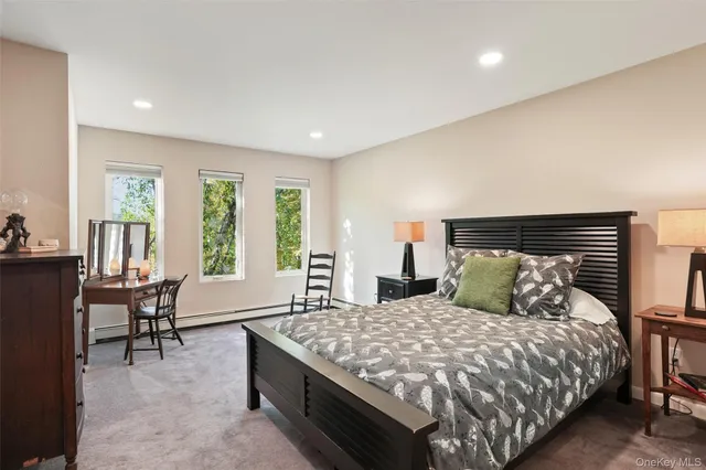 a bedroom with a large bed and a couch