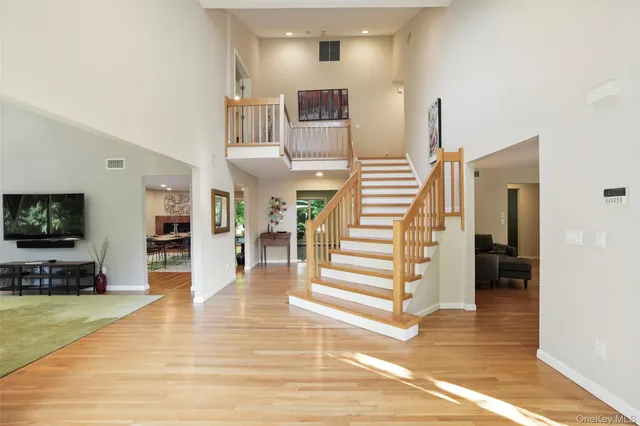 a view of a living room with furniture and wooden floor