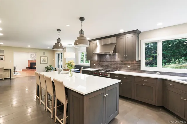 a kitchen with center island and stainless steel appliances