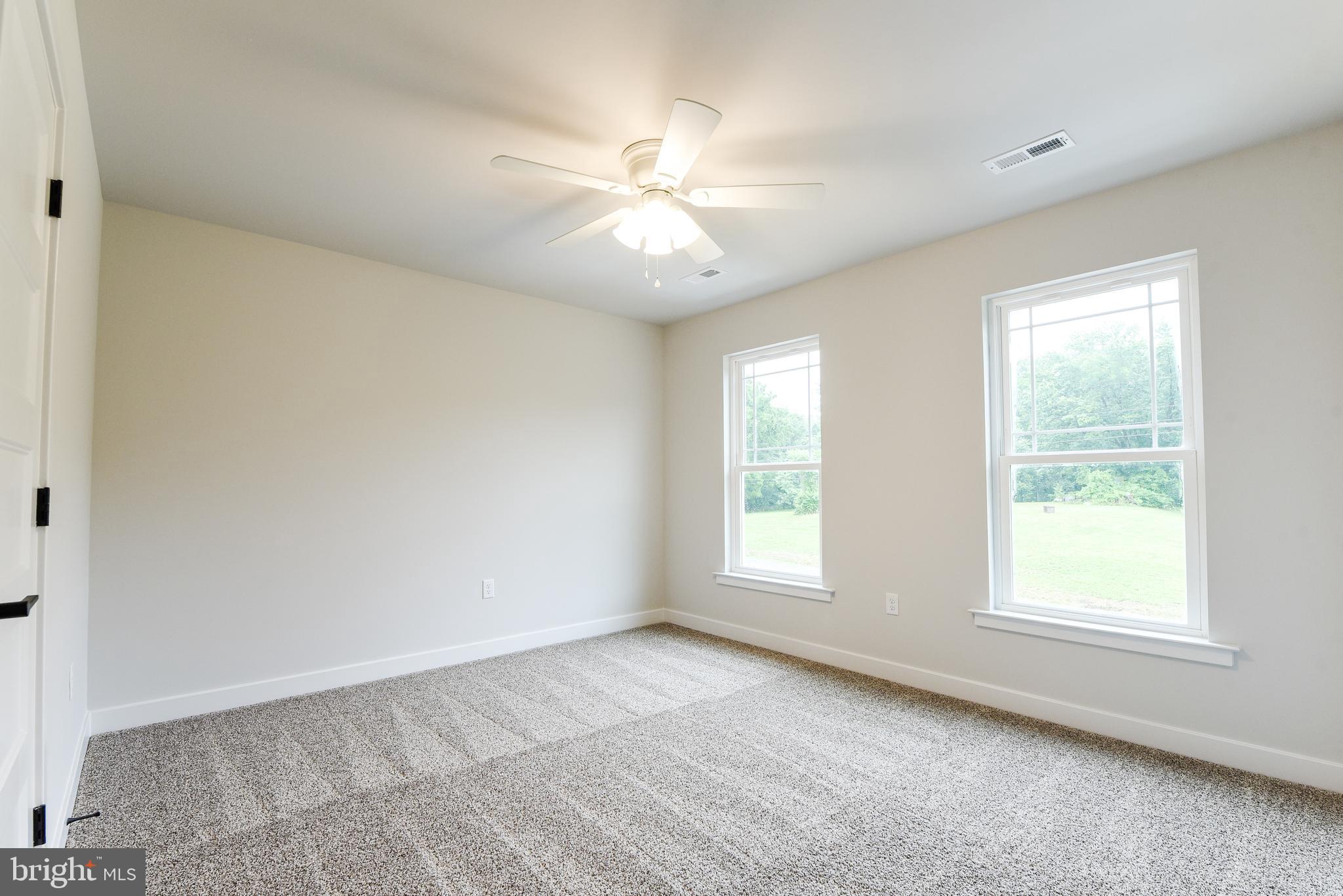 10631 Plank Road Spotsylvania, VA 22553 - Photo 19 of 26 an empty room with windows and fan